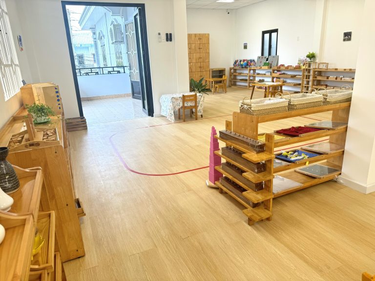 Không gian lớp Sunny ấm cúng với kệ gỗ tự nhiên an toàn và đầy đủ đồ dùng học tập Montessori